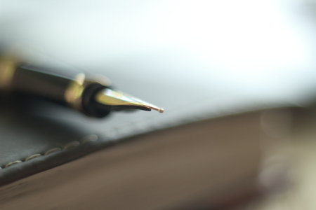 close up.blurred image of fountain pen on the desktop.business backgroundの写真素材
