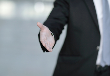closeup of a business man offering a handshake
