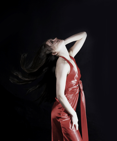 portrait of glamorous young woman in a red dress.の写真素材