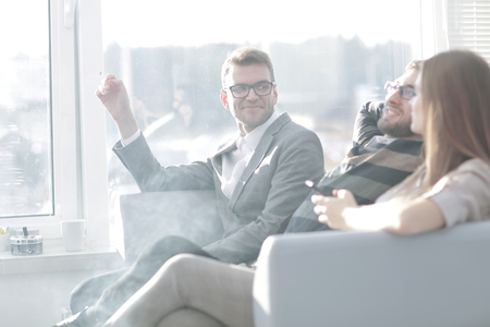 business team sitting on the couch during work break.の写真素材