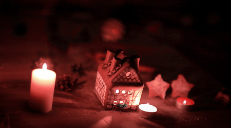 gingerbread house candle on blurred background of the table.の写真素材