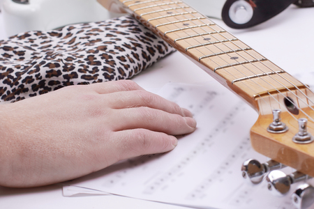 closeup of a guitarist touching sheet music .isolated on a whitの写真素材