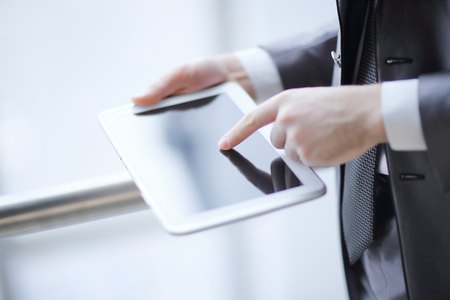 close up.businessman typing on a digital tablet