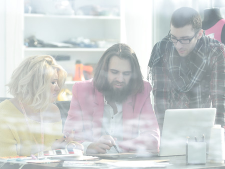 view from behind glass.creative team discusses new ideas in the Studioの写真素材