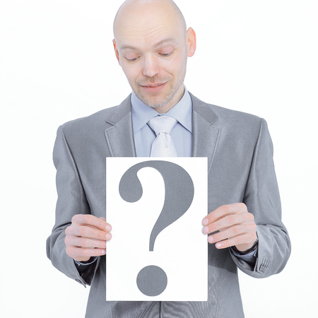 confident businessman holding a banner with a question markの写真素材