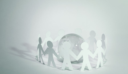 business background.team paper men standing around the glass globe.photo with copy spaceの写真素材