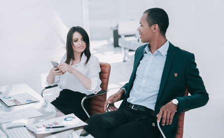 businessman and business woman sitting at a Desk.の写真素材