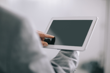 close up. a mans hand presses the screen of a digital tabletの写真素材