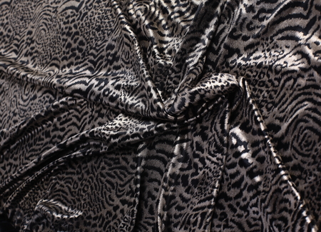 abstract background composed of leopard print fabric.