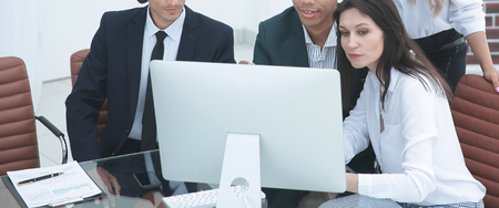 business people discussing financial information,sitting at his Deskの写真素材