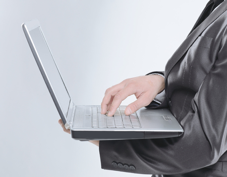 close up. businessman typing on laptop.isolated on whiteの写真素材