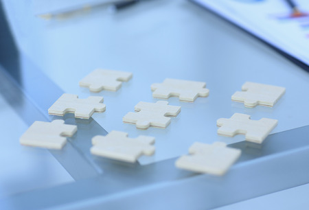 closeup.the pieces of the puzzle on the desktopの写真素材