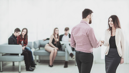 welcome handshake Manager and the client in the lobby of the officeの写真素材
