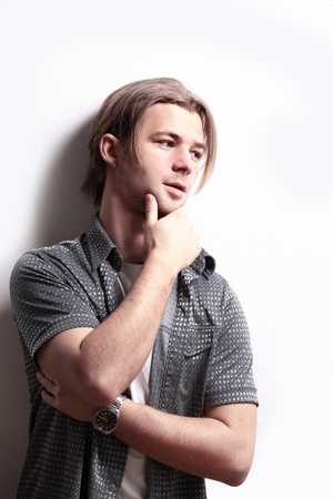 stylish guy leaning on wall.isolated on whiteの写真素材