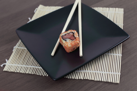 close-up of sushi and chopsticks on a wooden tableの写真素材