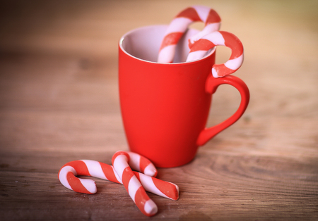 Christmas mug and candle on wooden background
