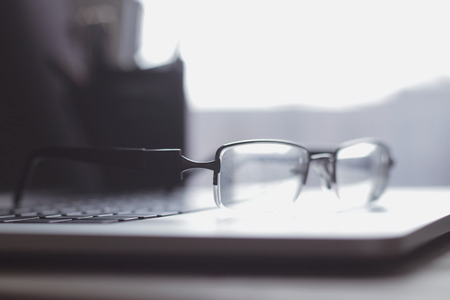 close up.blurred image of businessman glasses on laptop keyboard