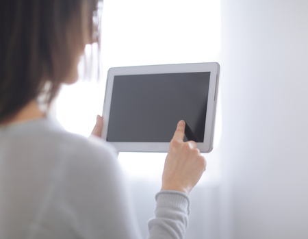close up. woman pressing her finger on the digital tablet screen .photo with copy space.の写真素材