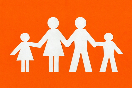 happy paper family on a bright orange background.photo with copy spaceの写真素材