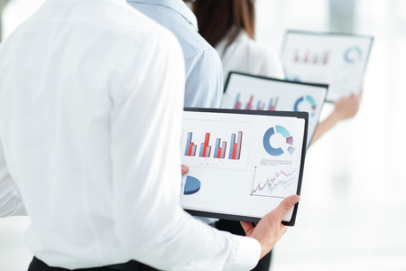 closeup.business team keeps files of financial graphs