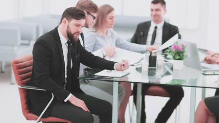 businessman working with business papers sitting at the Desk.photo with copy spaceの写真素材
