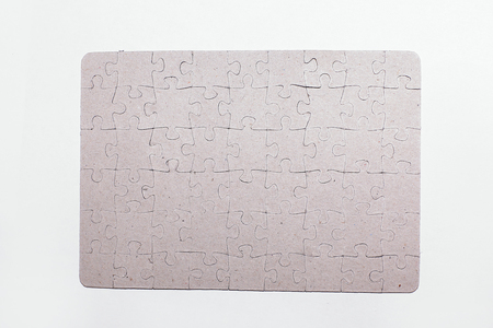 close up.blank shield assembled from puzzle pieces on white backの写真素材