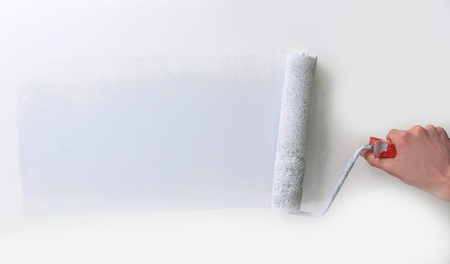 closeup.businessman drawing a paint roller on the wall.の写真素材