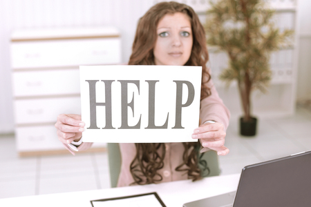 young business woman showing poster that says help.の写真素材