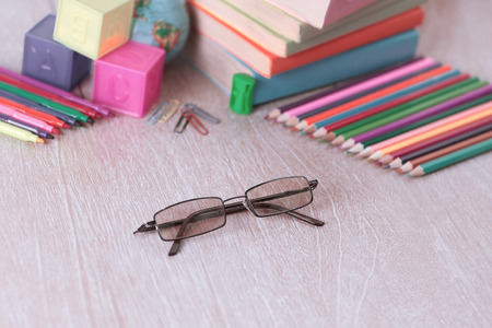 glasses and school supplies on wooden background.photo with copyの写真素材