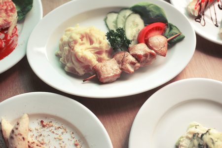 a variety of delicious dishes on the table in the restaurantの写真素材