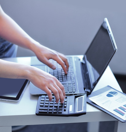 close up.man counting profit on a laptop