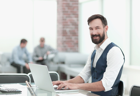 businessman sitting at his Desk in the officeの写真素材