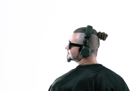 close up.side view. the rapper guy in the headphones is looking at a copy of the spaceの写真素材