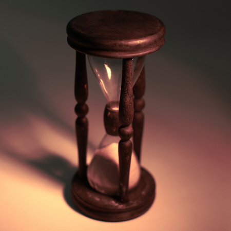 hourglass on a yellow background.The concept of time.