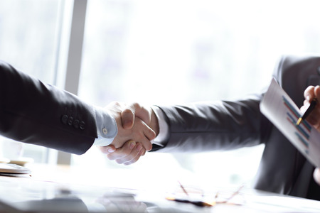 close up.handshake trading partners at the desktopの写真素材