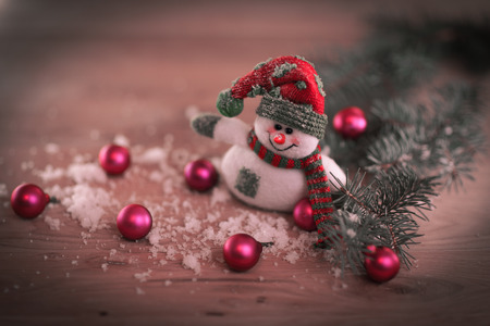 Christmas card. toy snowman on a festive background.の写真素材