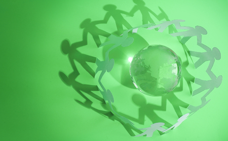 group of paper men standing around the glass globeの写真素材