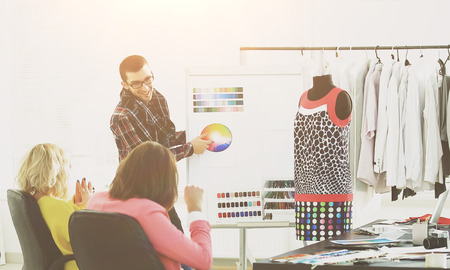 group of designers discussing a new clothing collectionの写真素材
