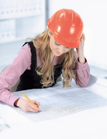 Business woman Drawing Blueprint At Office Deskの写真素材