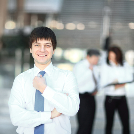 portrait of a successful young employee on blurred background officeの写真素材
