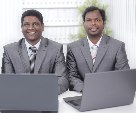 business partners discussing information with a laptop.の写真素材