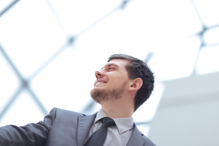 happy businessman on background of office windowの写真素材