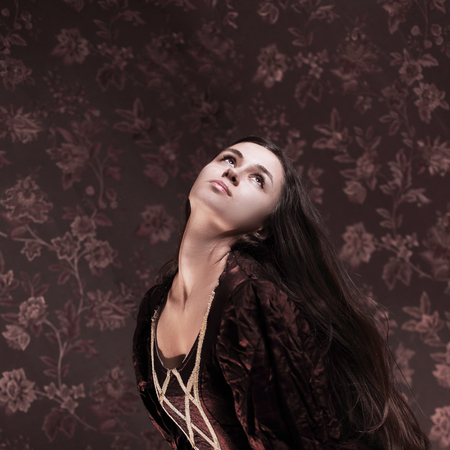 portrait of glamorous young woman in elegant dress.