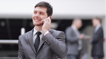 portrait of handsome businessman on blurred office backgroundの写真素材