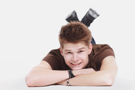 closeup. modern guy lying on the floor and looking at cameraの写真素材