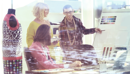 view from behind glass.designers discuss samples for the new collectionの写真素材