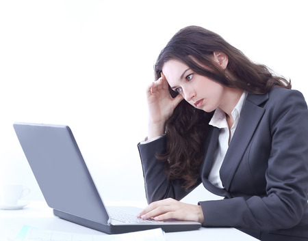 frustrated business woman sitting in front of an open laptopの写真素材