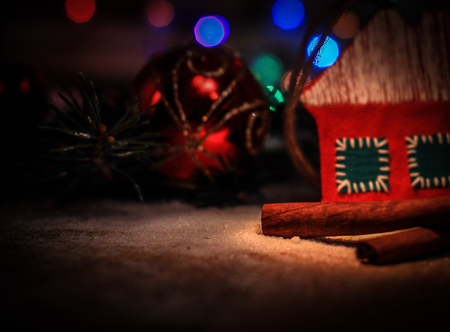 Christmas decorations and cinnamon sticks on a festive backgrouの写真素材