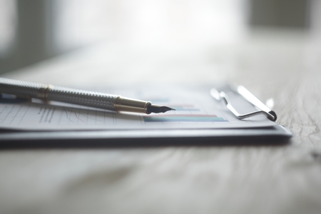 close up.pen and clipboard on the desktop .photo with copy space