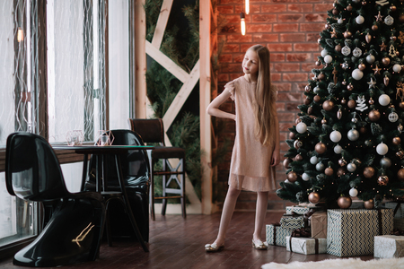 cute girl standing in a decorated living roomの写真素材
